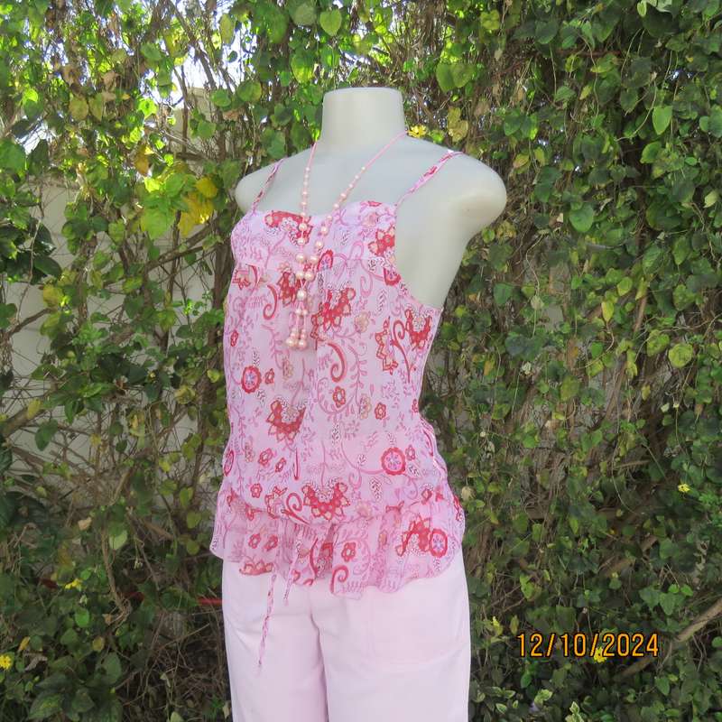 Chic slightly creased polyester pink top/red patterns. Size 34. Peplum frill.Drawstring waist.As new