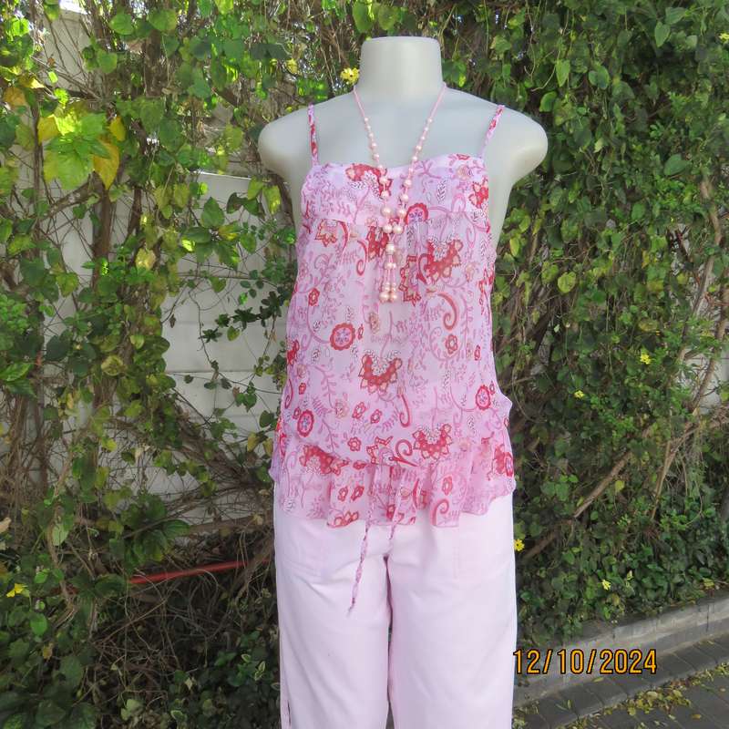 Chic slightly creased polyester pink top/red patterns. Size 34. Peplum frill.Drawstring waist.As new