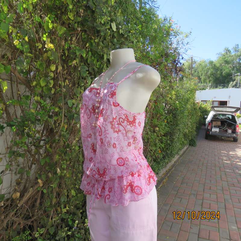 Chic slightly creased polyester pink top/red patterns. Size 34. Peplum frill.Drawstring waist.As new
