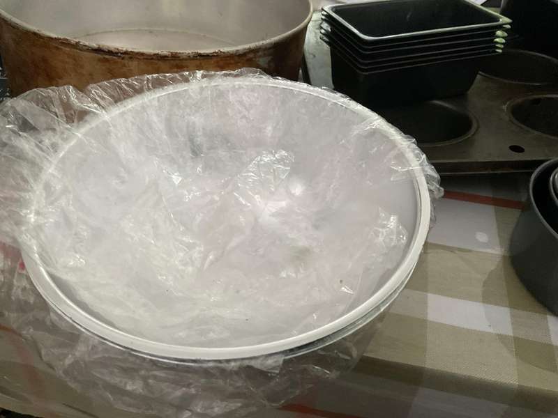 A selection of muffin baking trays, tart tins ,small cake tins and a large whisk.