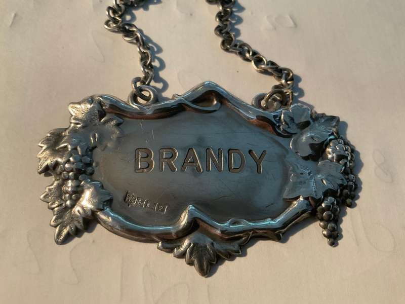 A sterling silver decanter label marked Brandy