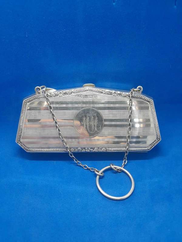 Silver coin purse with calf leather interior.