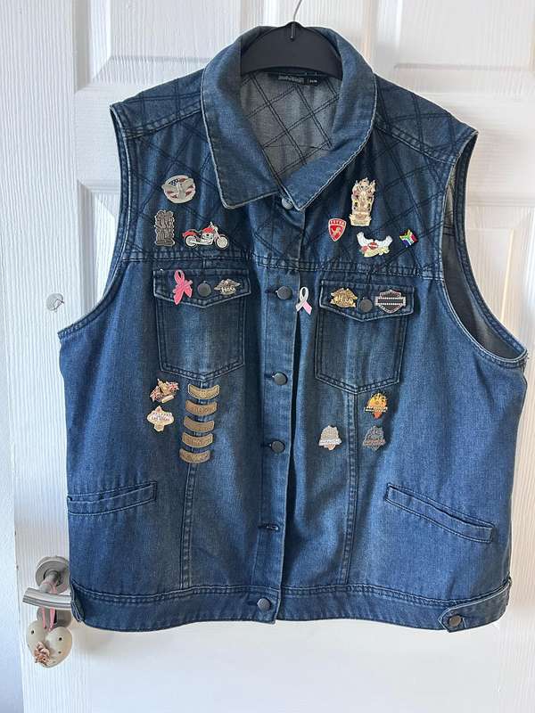 RENE TAYLOR denim motorcycle vest covered with a variety of pins and patches