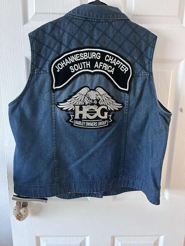 RENE TAYLOR denim motorcycle vest covered with a variety of pins and patches