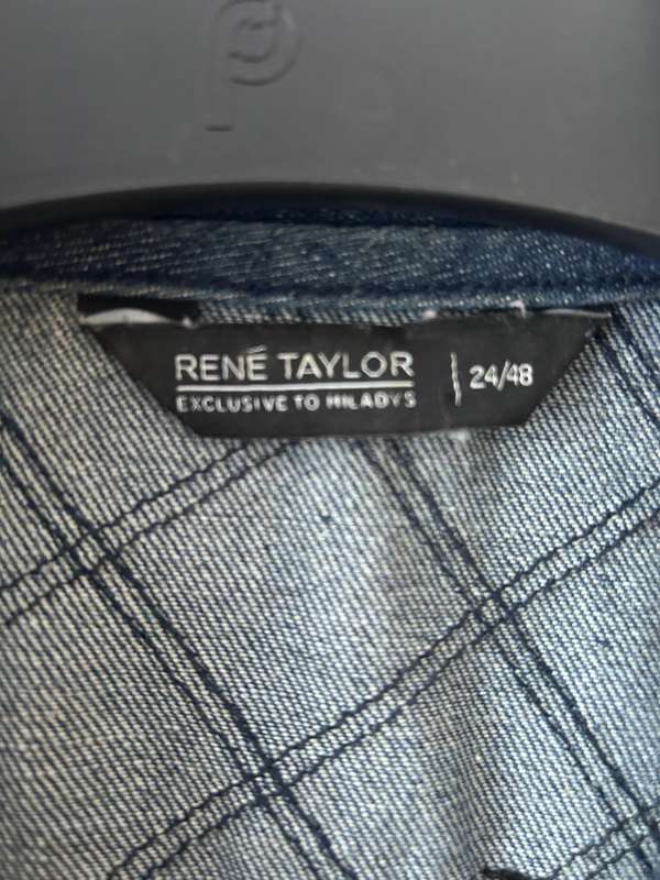 RENE TAYLOR denim motorcycle vest covered with a variety of pins and patches