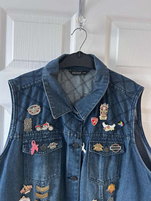 RENE TAYLOR denim motorcycle vest covered with a variety of pins and patches