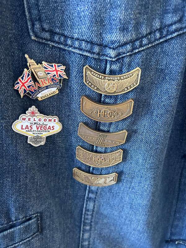 RENE TAYLOR denim motorcycle vest covered with a variety of pins and patches