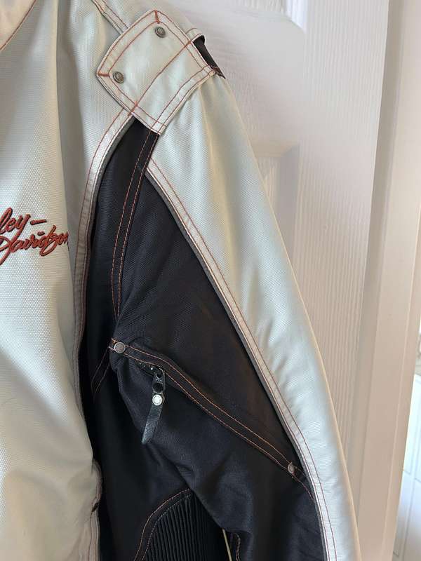 HarleyDavidson motorcycle jacket features a striking white body with black sleeves and red stitching