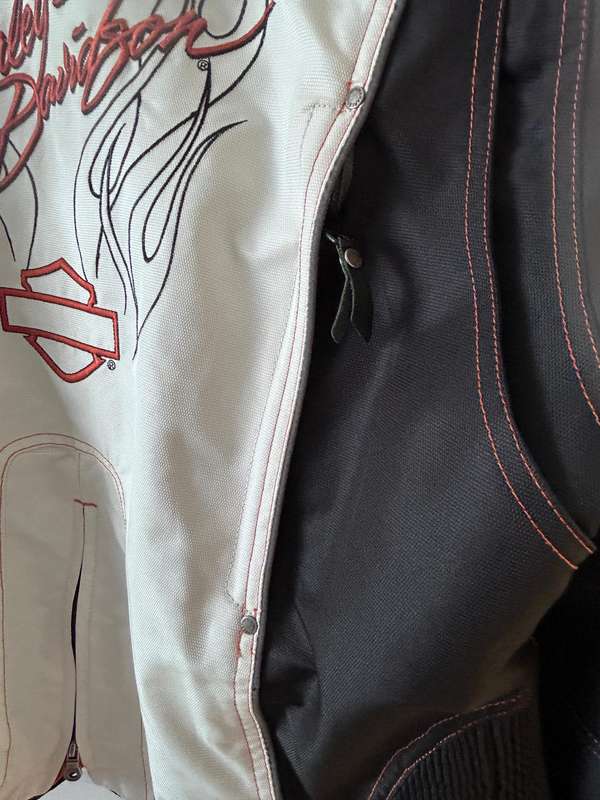 HarleyDavidson motorcycle jacket features a striking white body with black sleeves and red stitching