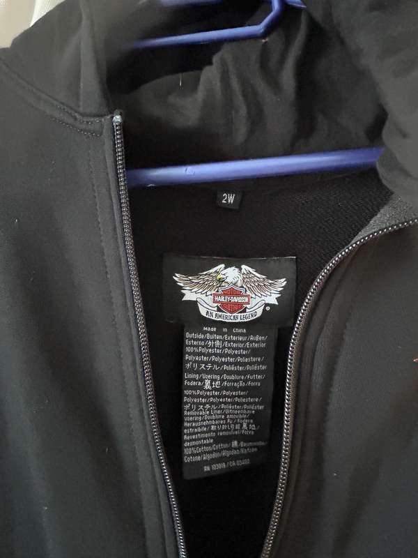 HarleyDavidson motorcycle jacket features a striking white body with black sleeves and red stitching