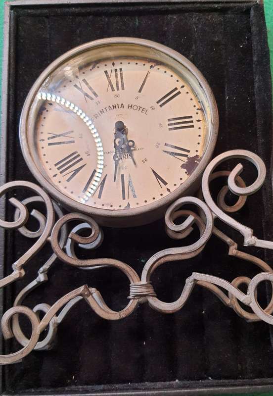 A VINTAGE TABLE TOP DECORATIVE IRON CLOCK