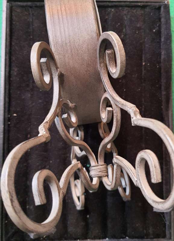 A VINTAGE TABLE TOP DECORATIVE IRON CLOCK