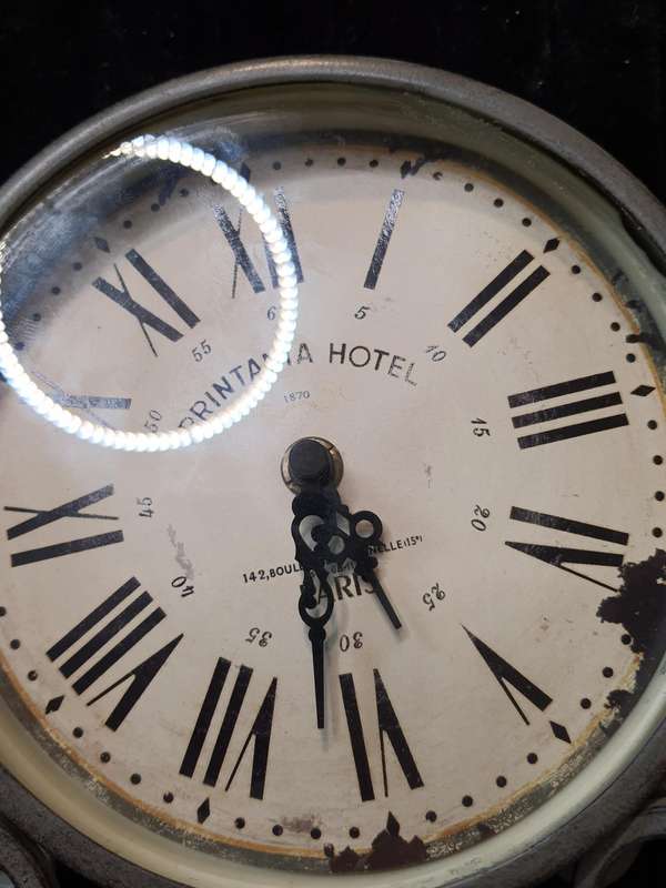A VINTAGE TABLE TOP DECORATIVE IRON CLOCK