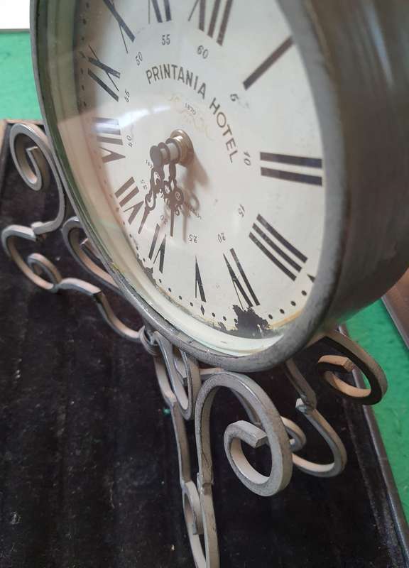 A VINTAGE TABLE TOP DECORATIVE IRON CLOCK