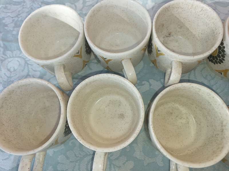 A VINTAGE STONEWARE SUNFLOWER DESIGN 24-PIECE TEACUP AND SAUCER SET
