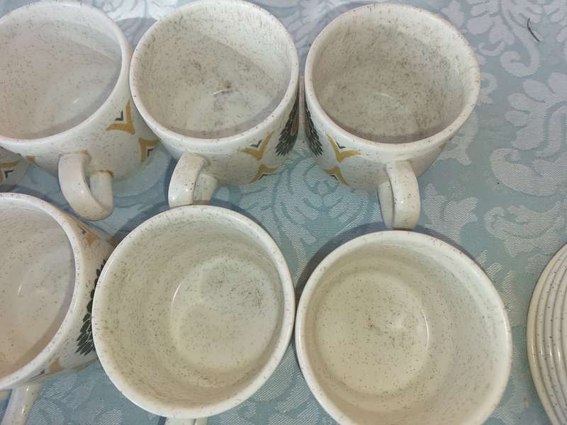A VINTAGE STONEWARE SUNFLOWER DESIGN 24-PIECE TEACUP AND SAUCER SET