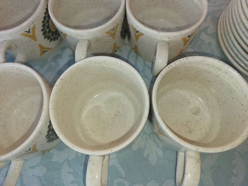 A VINTAGE STONEWARE SUNFLOWER DESIGN 24-PIECE TEACUP AND SAUCER SET
