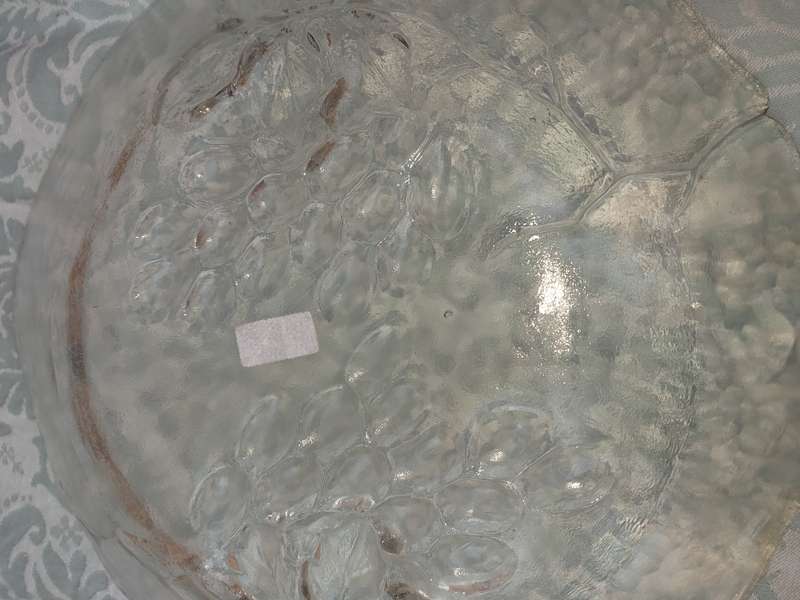 AN ART DECOR ROUND GLASS PLATTER WITH A GRAPE VINE DESIGN SOLD AS IS