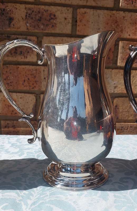 AN ANTIQUE COLLECTION SILVER PLATED WATER JUGS