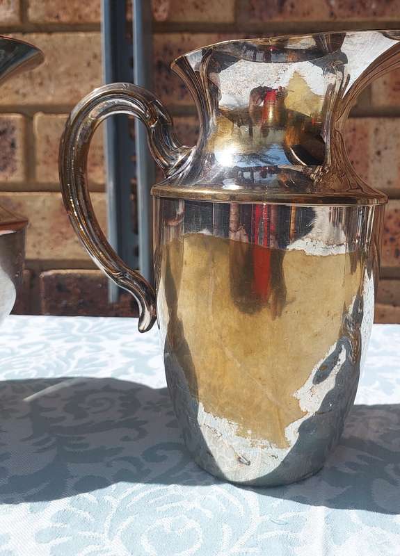 AN ANTIQUE COLLECTION SILVER PLATED WATER JUGS