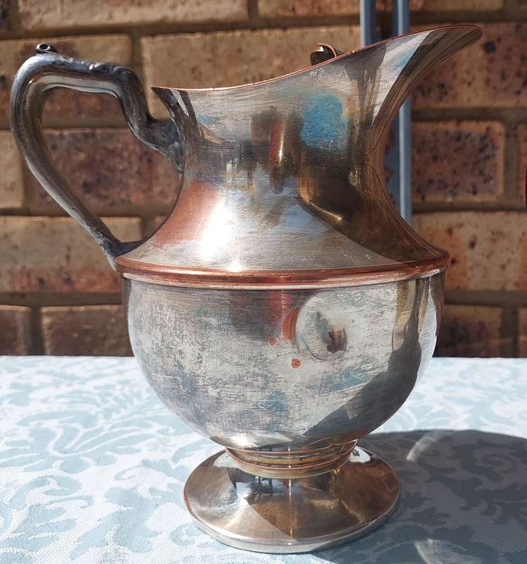 AN ANTIQUE COLLECTION SILVER PLATED WATER JUGS