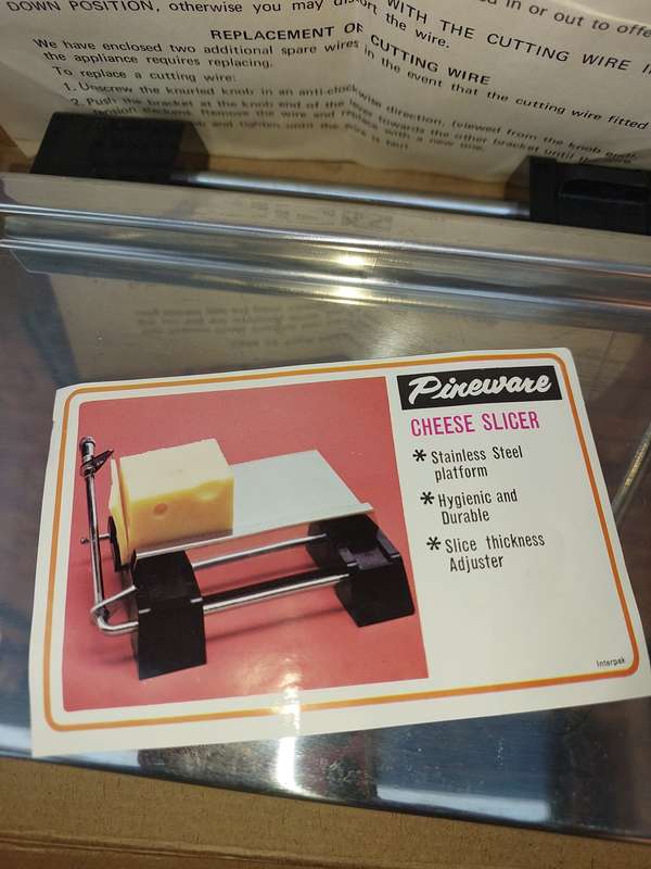 A VINTAGE PINE WARE CHEESE SLICER IN IT ORIGINAL PACKAGING