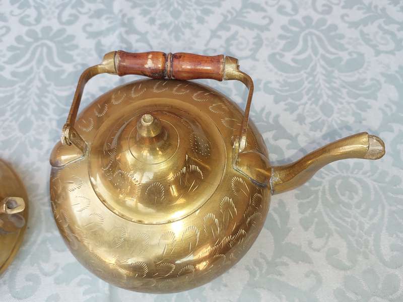 A SET OF BRASS ART DECOR KETTLES WITH AN ASIAN DESIGN