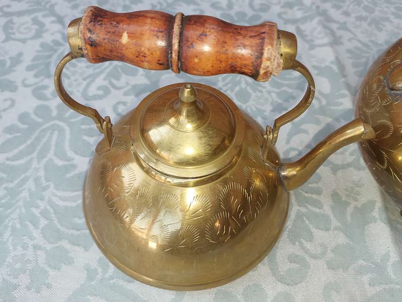 A SET OF BRASS ART DECOR KETTLES WITH AN ASIAN DESIGN
