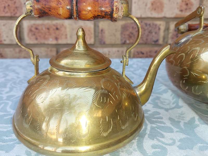 A SET OF BRASS ART DECOR KETTLES WITH AN ASIAN DESIGN