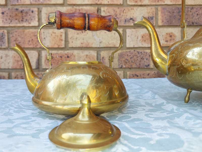 A SET OF BRASS ART DECOR KETTLES WITH AN ASIAN DESIGN