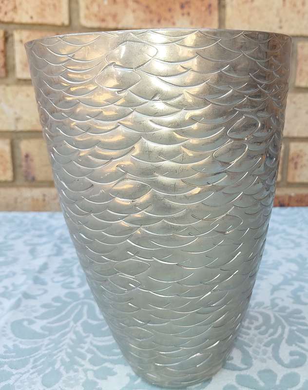 A FISH SCALE PATTERNED STEEL VASE