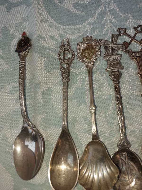 A COLLECTION OF SPOONS SOLD AS IS