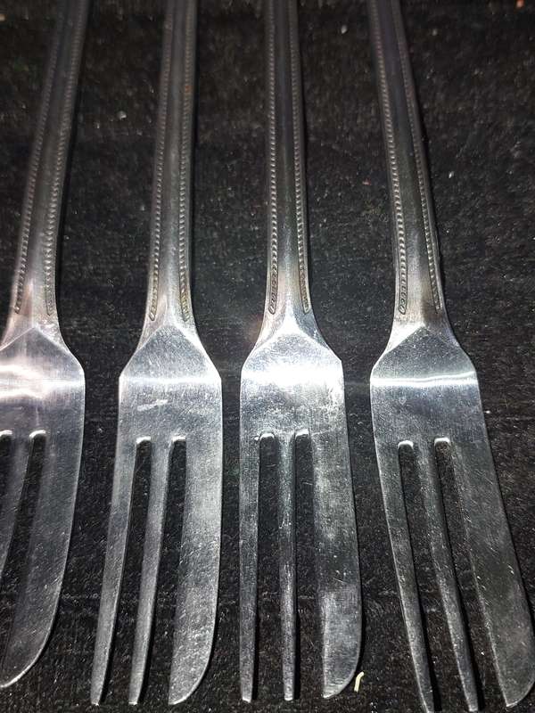 A SET OF 7 STAINLESS STEEL BELLERINA TWIST CAKE FORKS