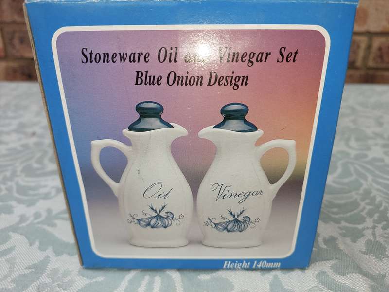 A STONEWARE  OIL AND VINEGAR SET BLUE ONION DESIGN