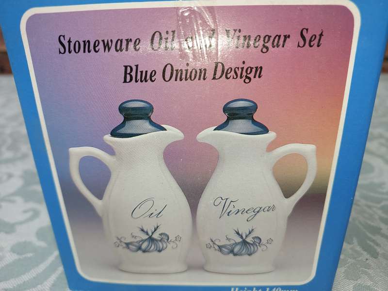 A STONEWARE  OIL AND VINEGAR SET BLUE ONION DESIGN