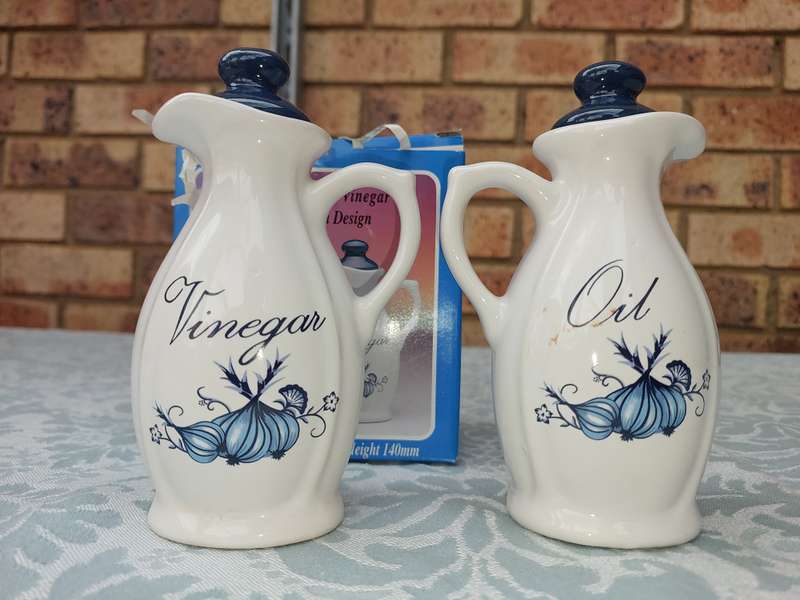 A STONEWARE  OIL AND VINEGAR SET BLUE ONION DESIGN