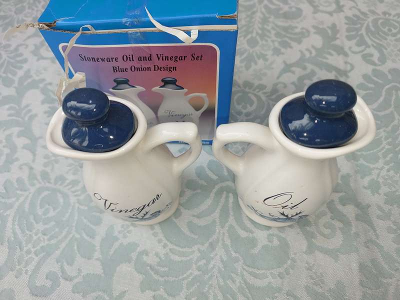 A STONEWARE  OIL AND VINEGAR SET BLUE ONION DESIGN