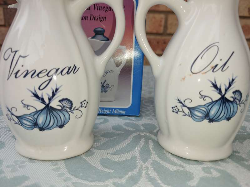 A STONEWARE  OIL AND VINEGAR SET BLUE ONION DESIGN