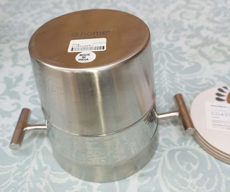 A STAINLESS STEEL ICE BUCKET AND A SET OF 4 COASTERS
