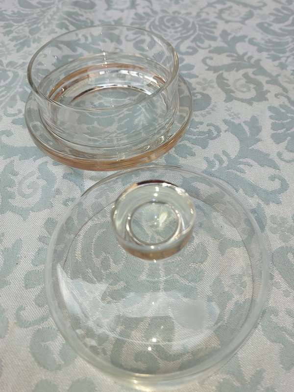 A SOLID GLASS BUTTER BOWL WITH A LID