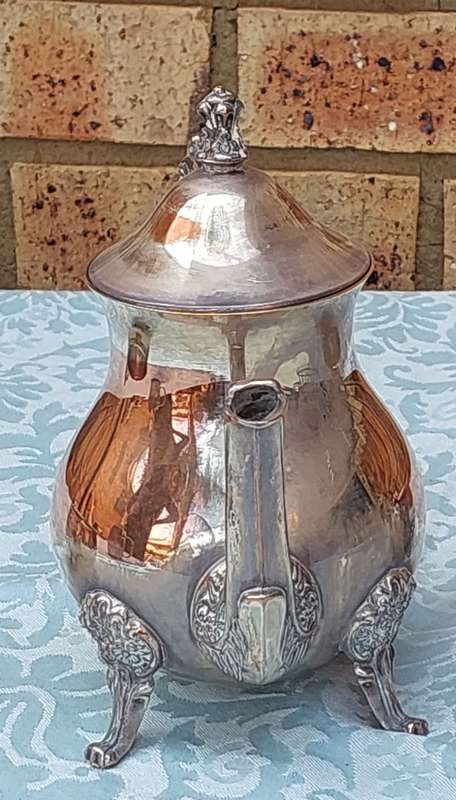 AN ANTIQUE TEA JUG, A SUGAR AND MILK SET