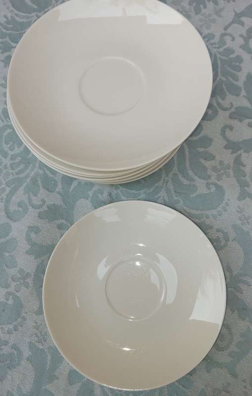 A COLLECTION OF 9 STUDIO WHITE PORCELAIN SAUCERS
