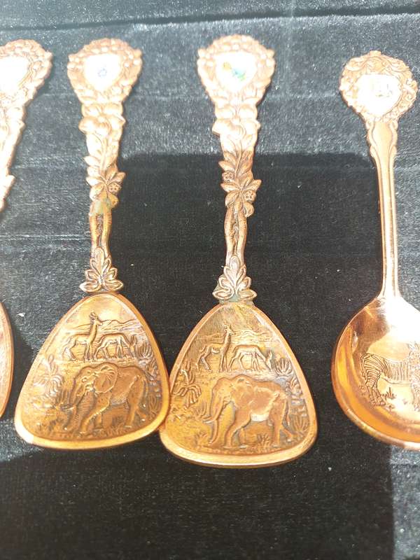 A COLLECTION OF 11 COPPER AFRICAN GAME ANIMAL MEMORABILIA SPOONS