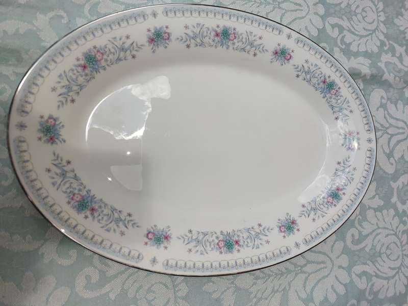 A VINTAGE PORCELAIN OVAL SHAPED WITH A SILVER INLAY PLATTER