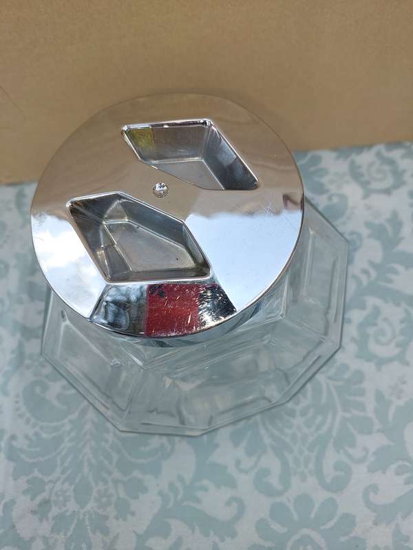 A GLASS SWEAT JAR WITH A STAINLESS STEEL LID SOLD AS IS