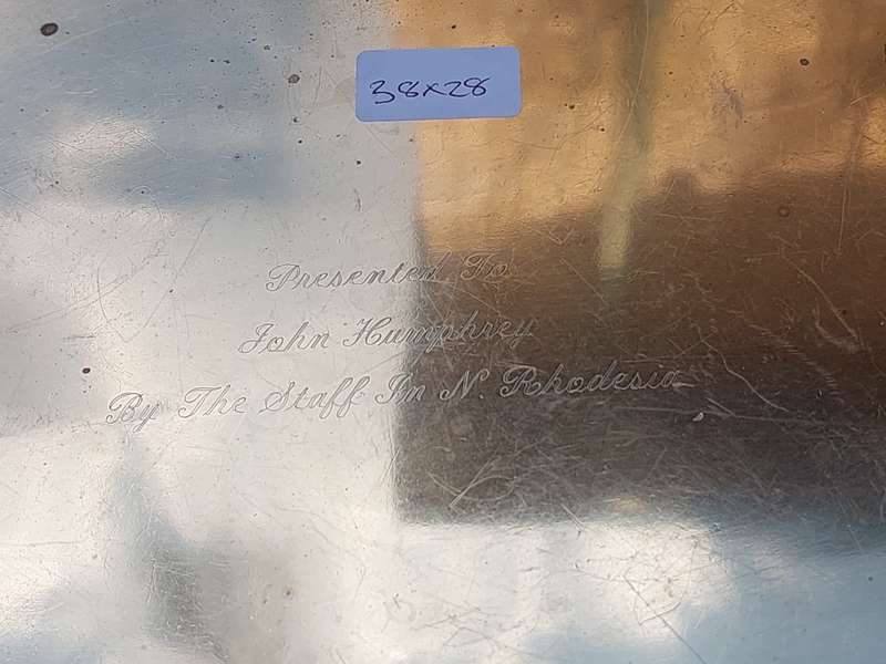 A SILVER-PLATED ON BRASS PLAQUE WITH ENGRAVINGS ON IT SOLD AS IS