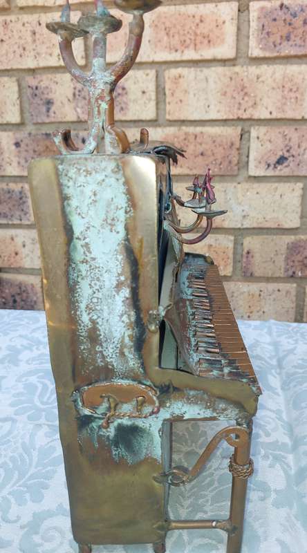 A COLLECTION OF COPPER FIGURINE ART SCULPTURES A PIANIST ,A PIANO WITH A SAXOPHONIST AND A BICYCLE