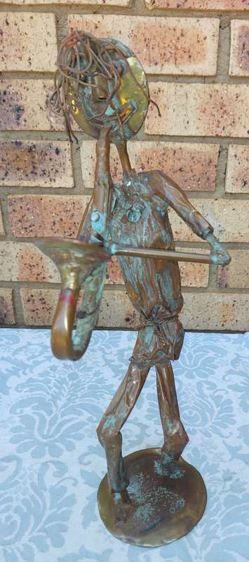 A COLLECTION OF COPPER FIGURINE ART SCULPTURES A PIANIST ,A PIANO WITH A SAXOPHONIST AND A BICYCLE