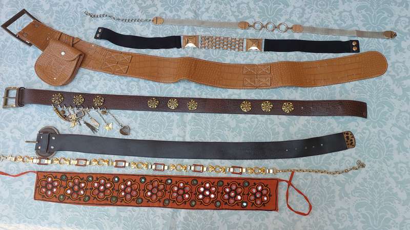 A COLLECTION OF FASHION WOMANS BELTS SOLD AS IS