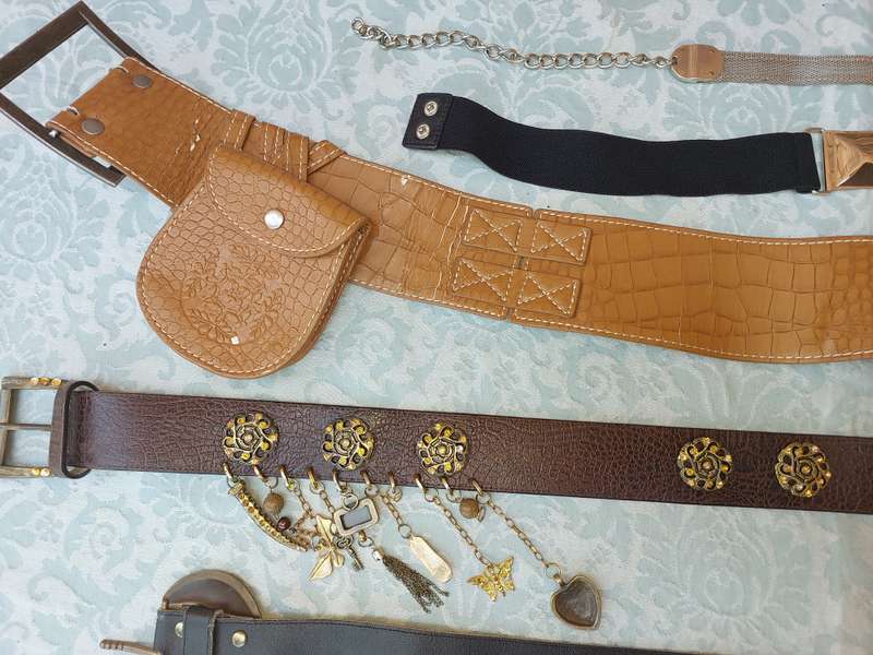 A COLLECTION OF FASHION WOMANS BELTS SOLD AS IS